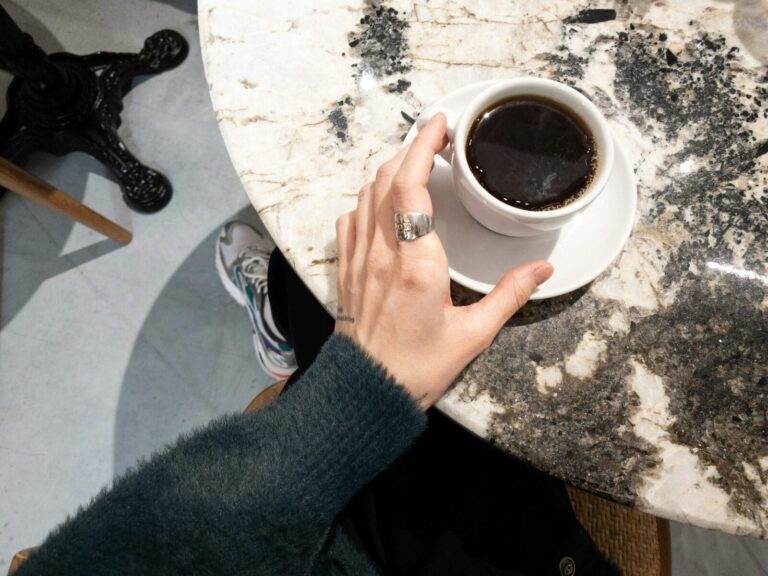 woman holding cup of coffee