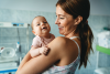 A mother holding her newborn baby for protection against seasonal flu and illness.
