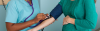 Female doctor checking the blood pressure of a pregnant woman during a prenatal checkup for hypertension.